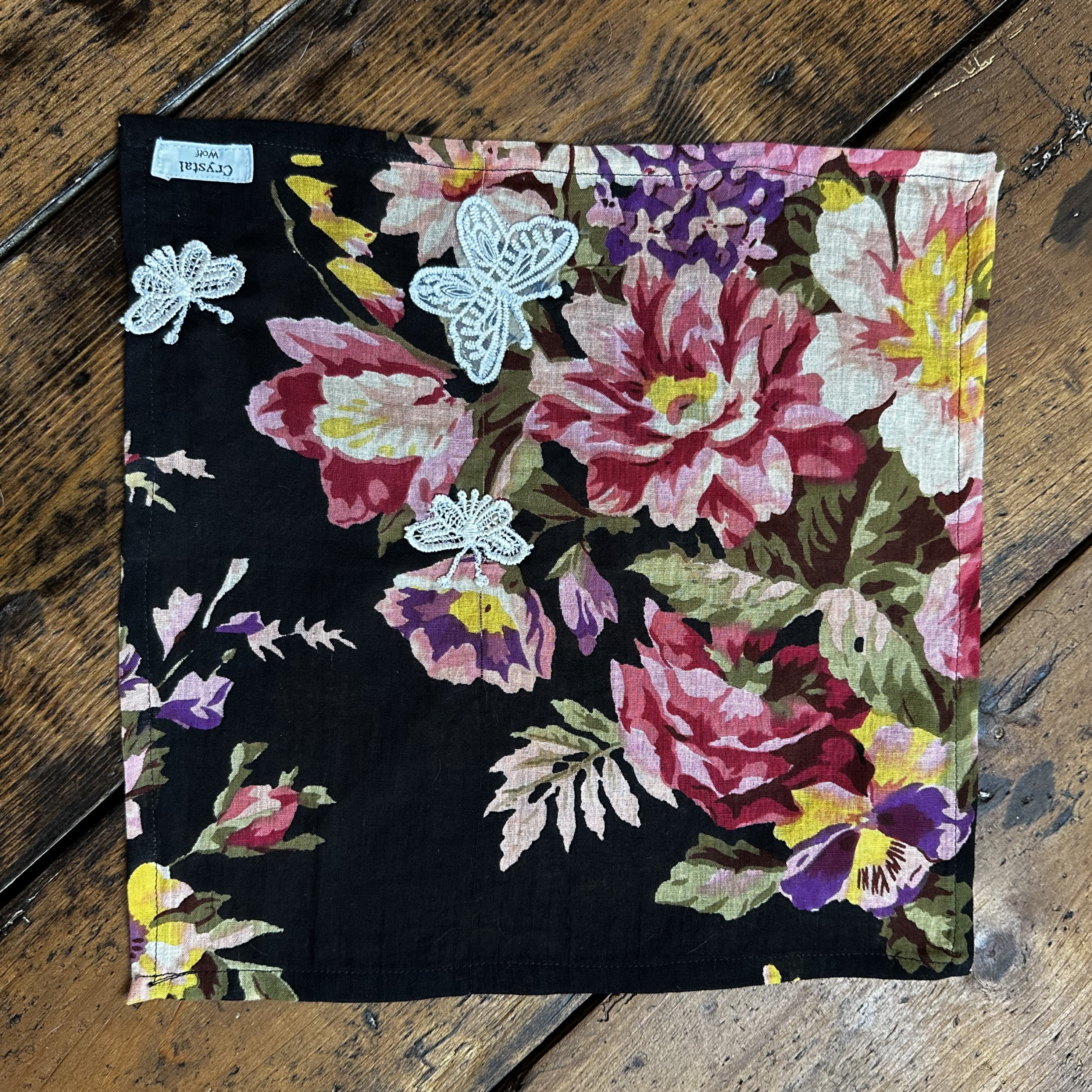 Black floral dog bandana with embroidered butterfly details.