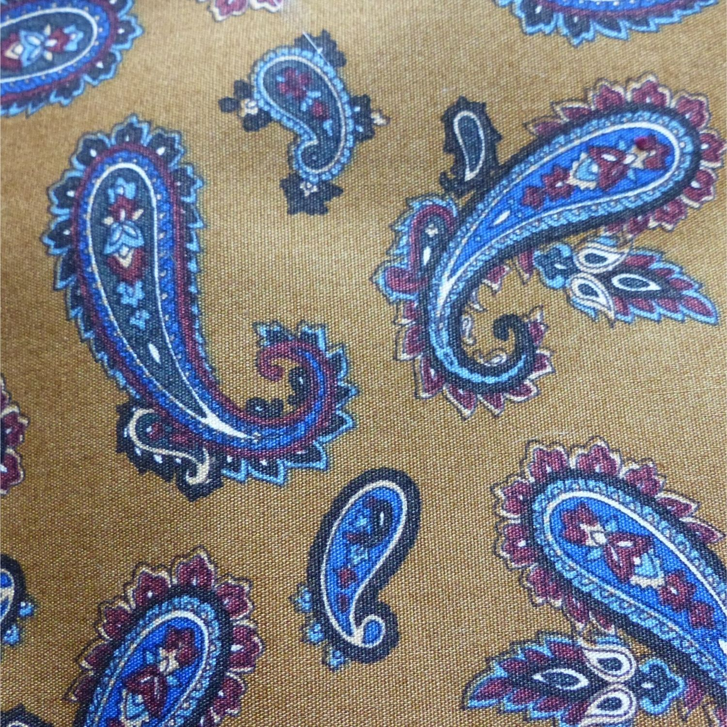 Paisley-patterned fabric in rich caramel tones