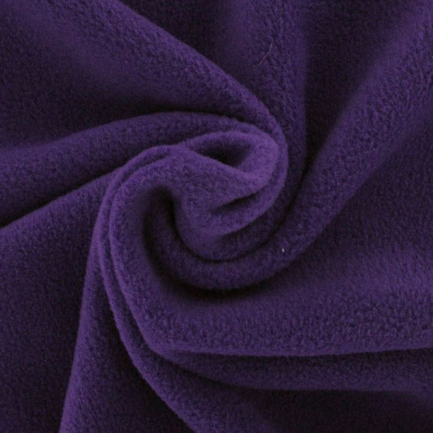 “Close‑up view of rich purple fleece fabric, showing its plush, fuzzy texture and gentle surface detail.”
