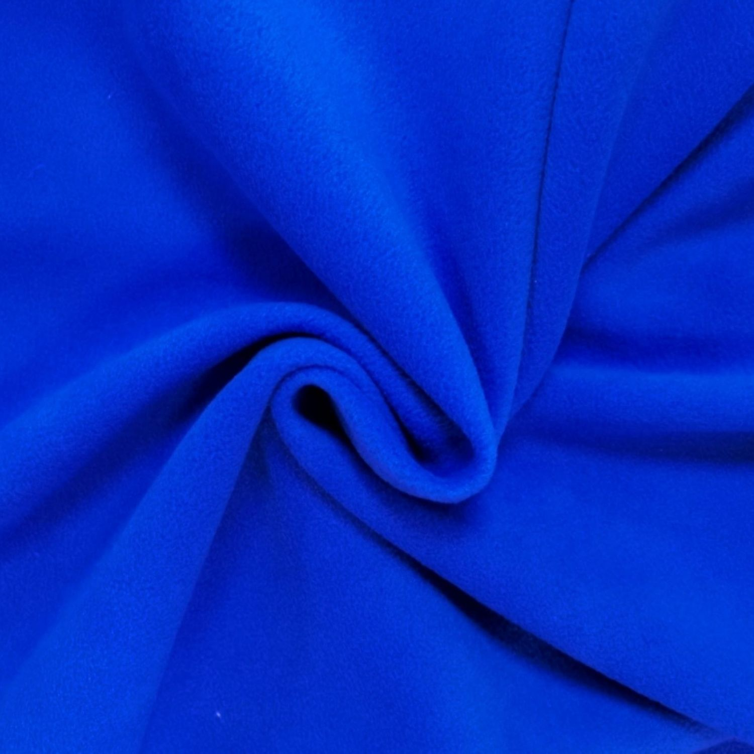 “Close‑up view of royal blue fleece fabric, showing its soft, plush, and slightly fuzzy texture.”