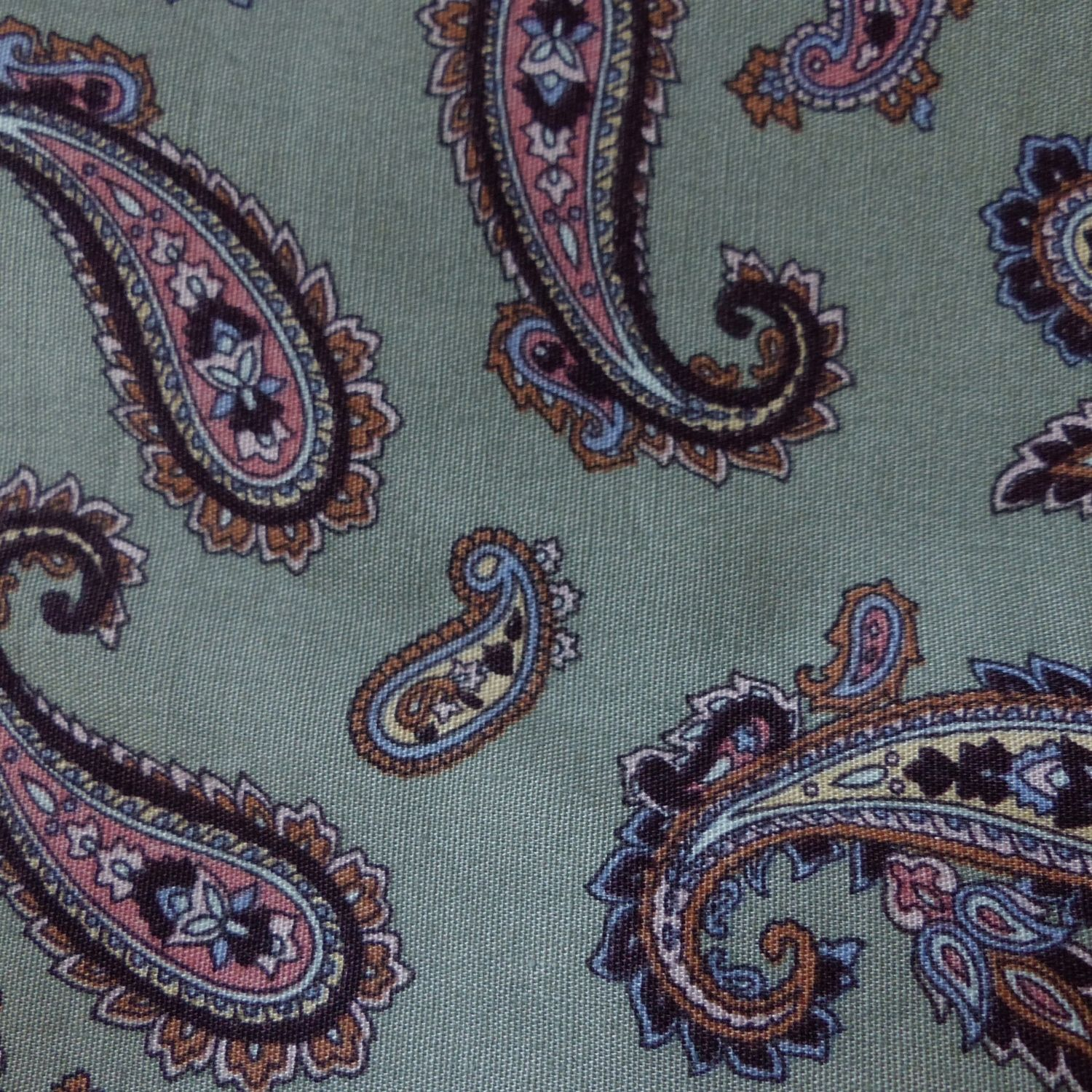Paisley-patterned fabric in rich green tones