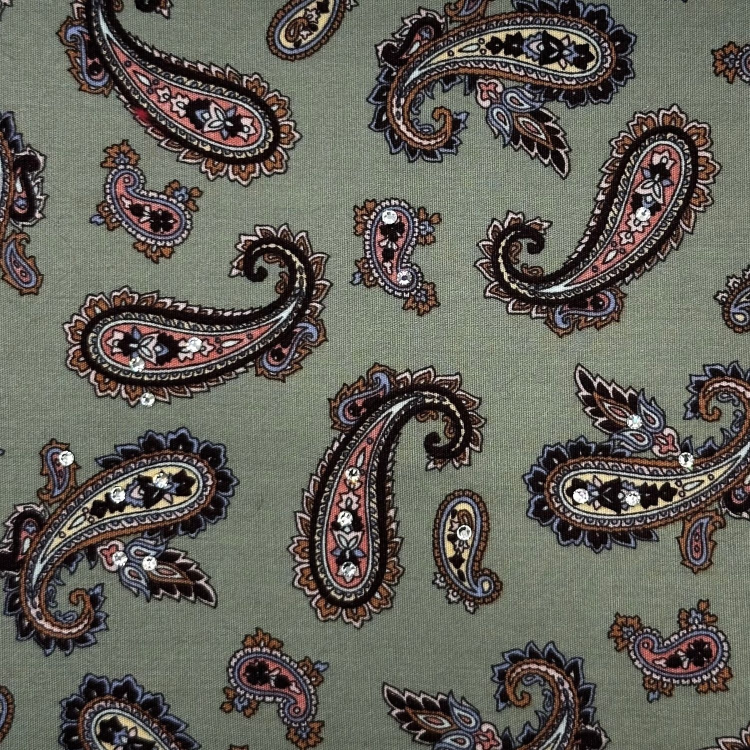 Paisley-patterned fabric in rich green tones, embellished with sparkling crystals.